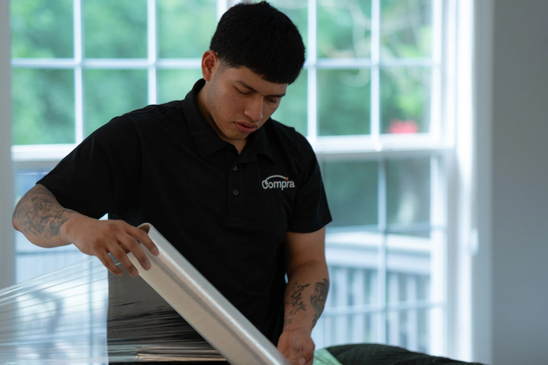 Professional packer carefully wrapping fragile glassware